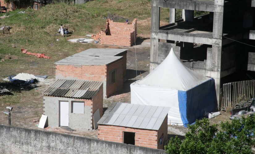 No terreno particular é possível ver três construções em tijolos e uma barraca de lona