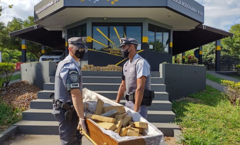 Policiais carregam caix&atilde;o com drogas apreendidas em Limeira, no interior de SP