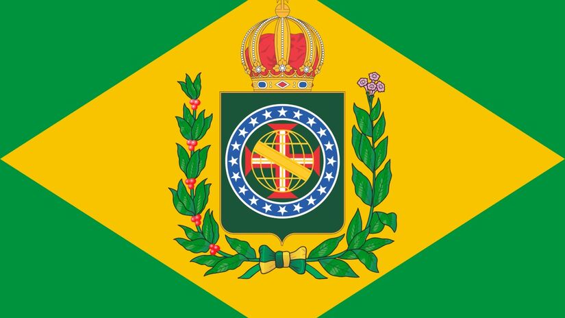 A bandeira do Brasil foi criada por Raimundo Teixeira Mendes e Miguel Lemos, com desenho de Décio Vilares, inspirada na Bandeira do Império de 1822, que exibia um brasão com ramos de café, tabaco e uma coroa dourada. Foto: Wikimedia Commons