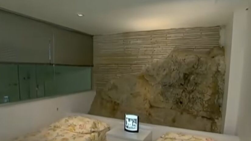 De cima da rocha, a casa tem vista ampla para a Enseada e fica praticamente isolada do movimento da orla, mesmo estando em uma das regiões mais valorizadas do Guarujá. Fotos: Reprodução YT/Record TV