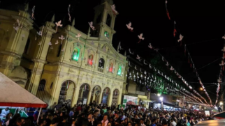 Igreja iluminada e ruas cheias resumem o encontro entre devoção, gastronomia e vida comunitária que marca a festa no Bixiga. (Foto: Wikimedia Commons)