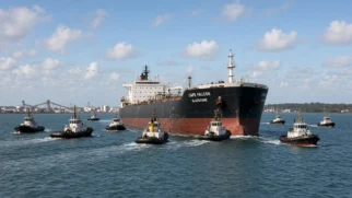 Dez rebocadores tentando mover o Cape Falcon encalhado perto de Gladstone na Austrália