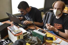 Hackers working on Linux laptop with computer disks and repair kits - Milano 2022.jpg