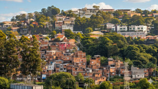 A poucos metros de condomínios de alto padrão, Paraisópolis expõe como renda, moradia, saúde e calor extremo convivem lado a lado em São Paulo.