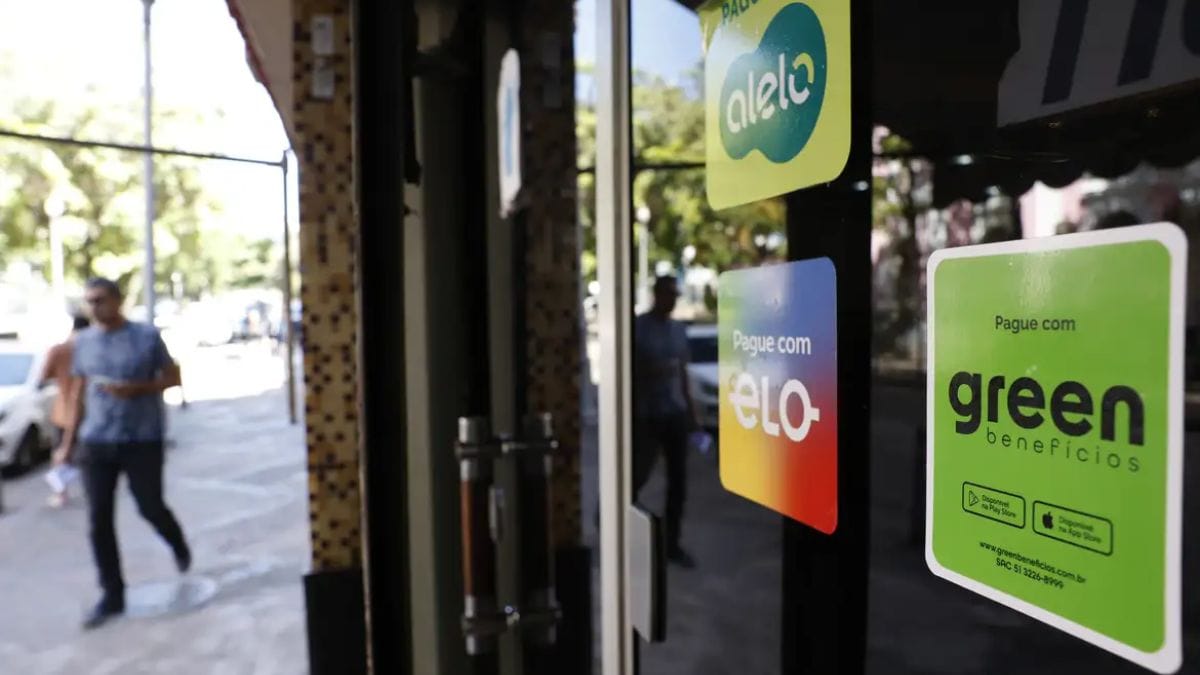 Estabelecimentos comerciais exibem adesivos de diversas operadoras; fim da "bandeira única" é a principal mudança no VA e VR 2026. Fernando Frazão/Agência Brasil