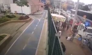 Vídeo de câmera de segurança mostra o momento em que um homem de camiseta branca cai no chão e é alvejado por outro